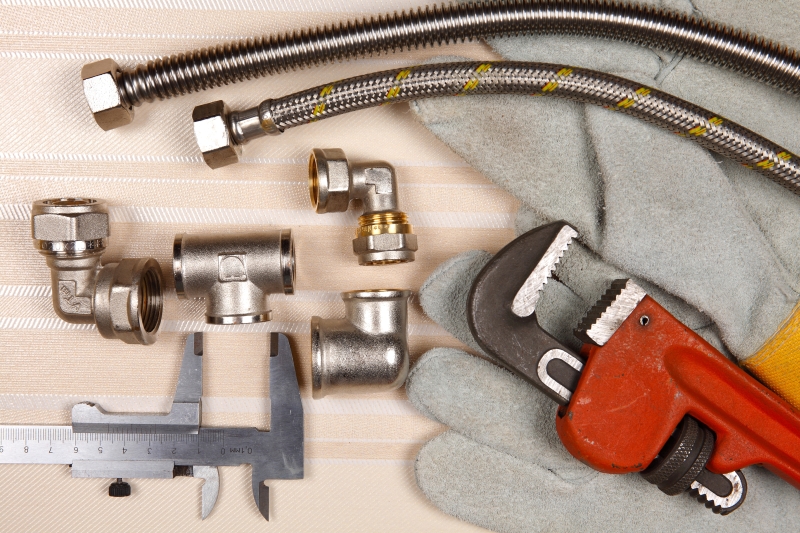 Plumber working on pipes in a Peckham home